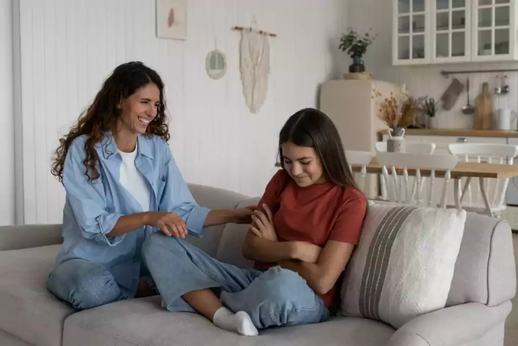 Parent discussing food positively with child on the couch.