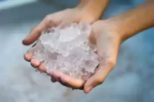 Persons hand holding ice as coping technique.