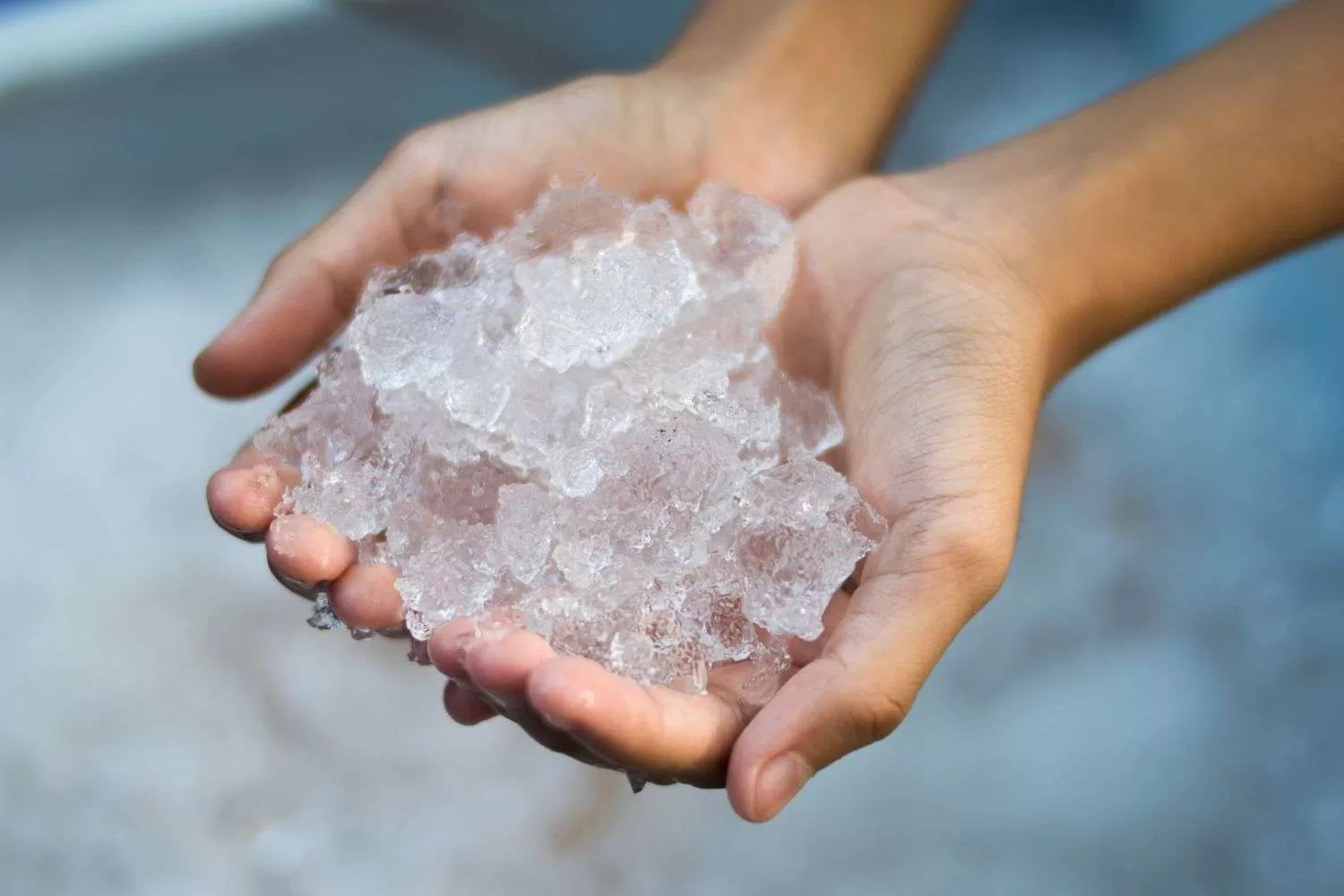 Persons hand holding ice as coping technique.