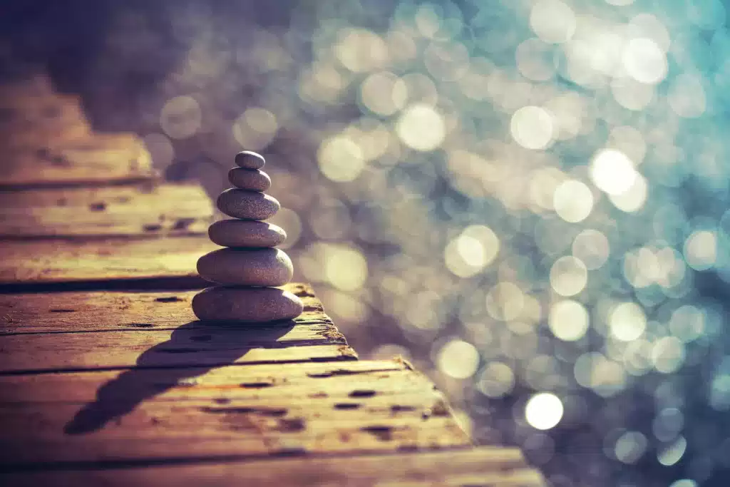 Tranquil image of rocks on a pier over the water.