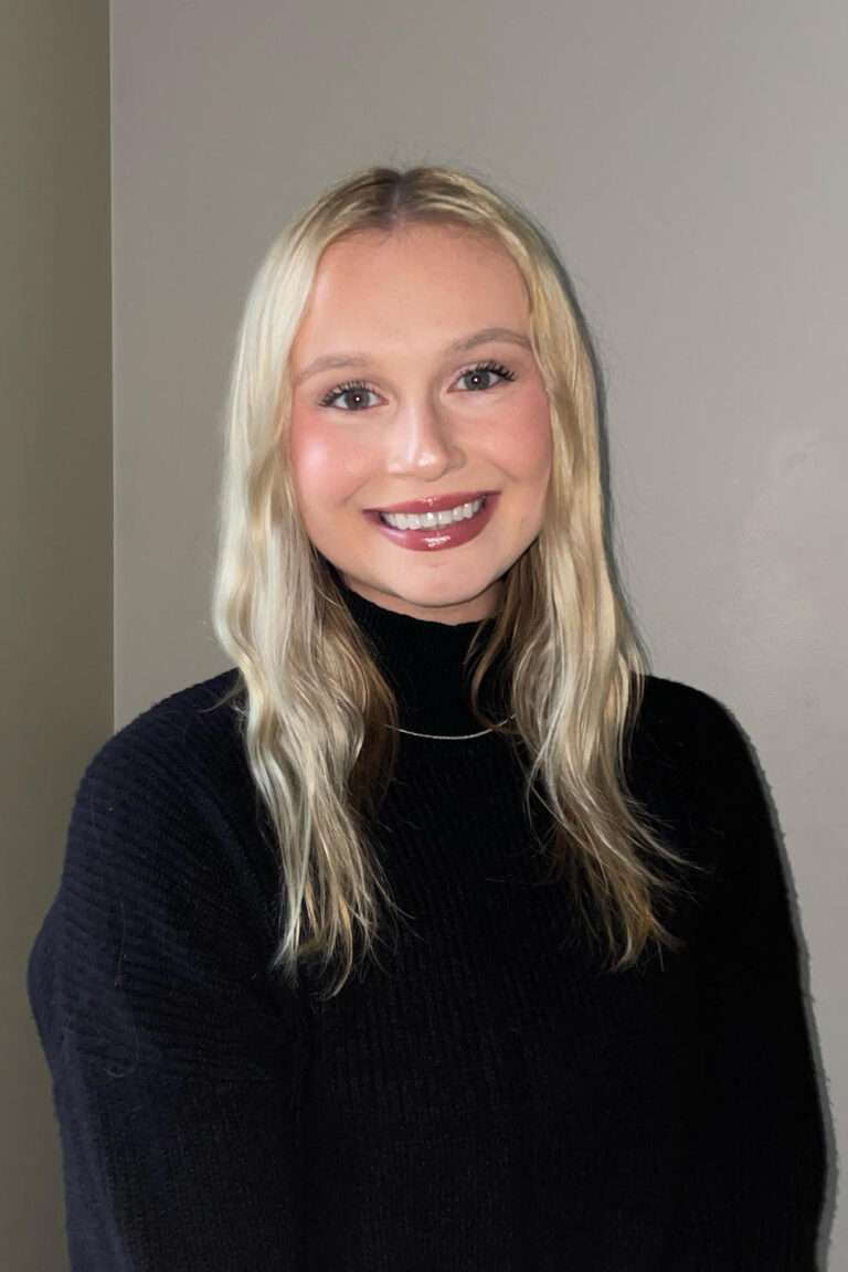 Professional photo of McKenzie Korhorn in a black sweater.