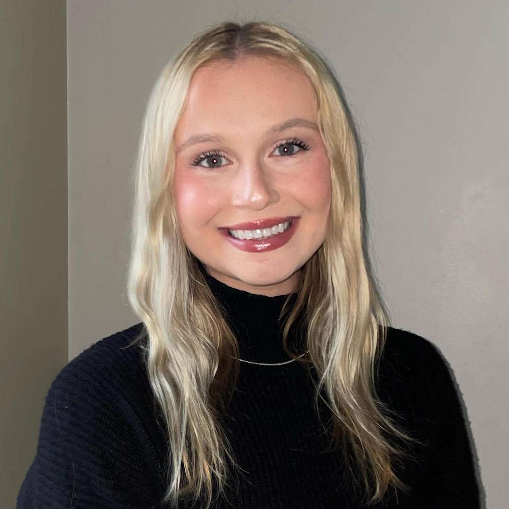 Professional headshot of McKenzie Korhorn in a black sweater.