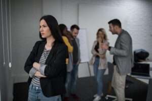 Woman with back turned to small group of people talking about diets.