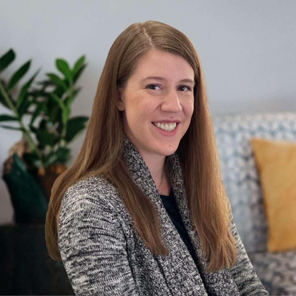 Headshot of Hannah McDaniel in grey and black sweater.