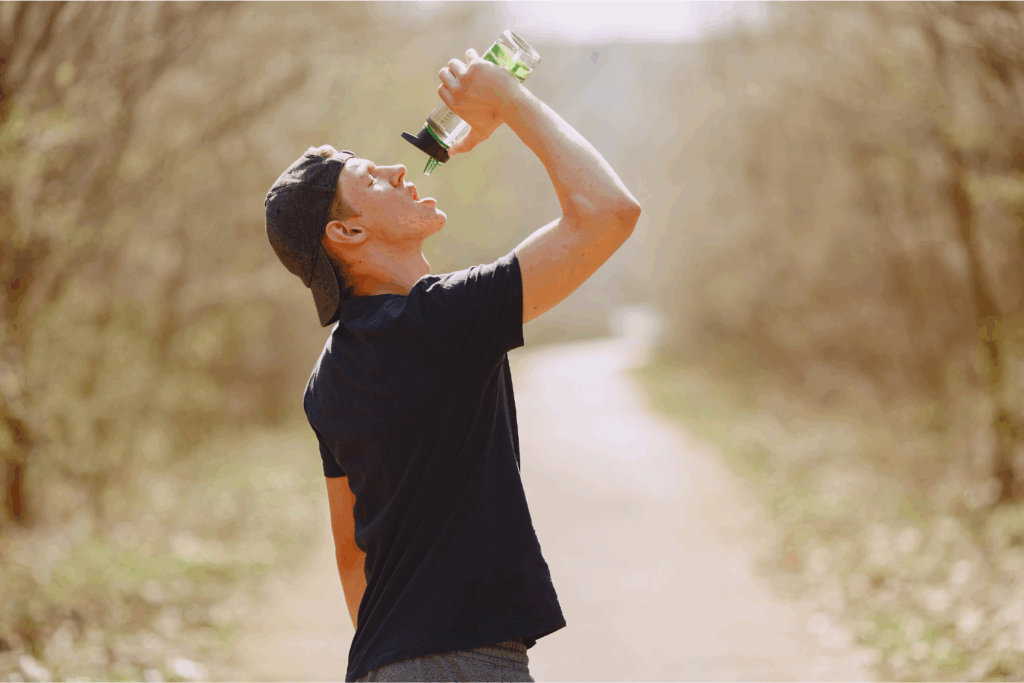 Hydration for Athlete Recovery - Athlete Drinking Water on Trail