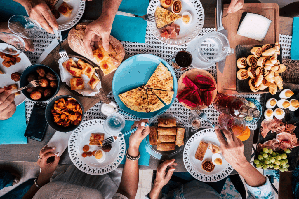 a group of people sharing meals together, showing that food variety is important