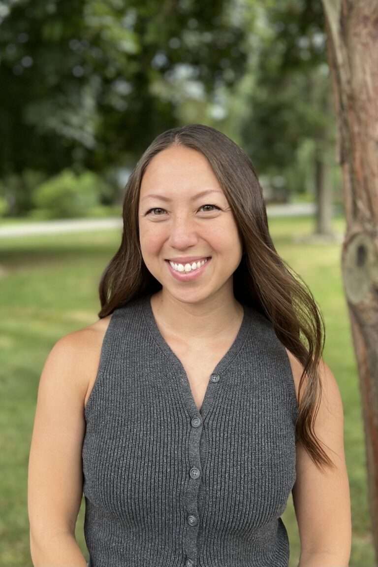 Shannon Stevens, registered dietitian and certified eating disorder specialist, standing outside by a tree.