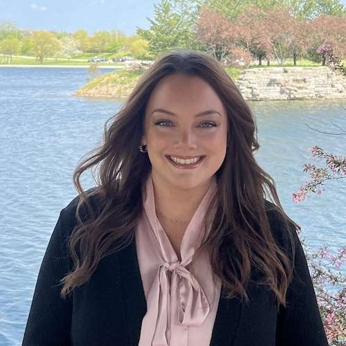 Adolescent and Teen Dietitian, Megan Fallon standing in front of a body of water.